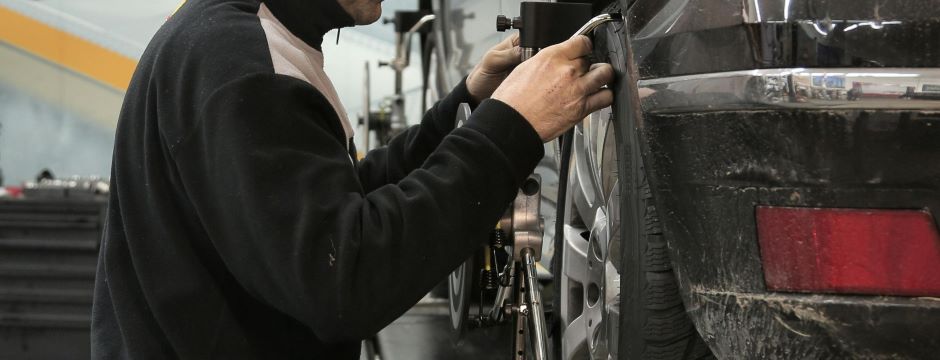 person working on a car tire